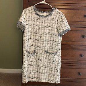 Short-sleeve tweed shift dress with pockets.